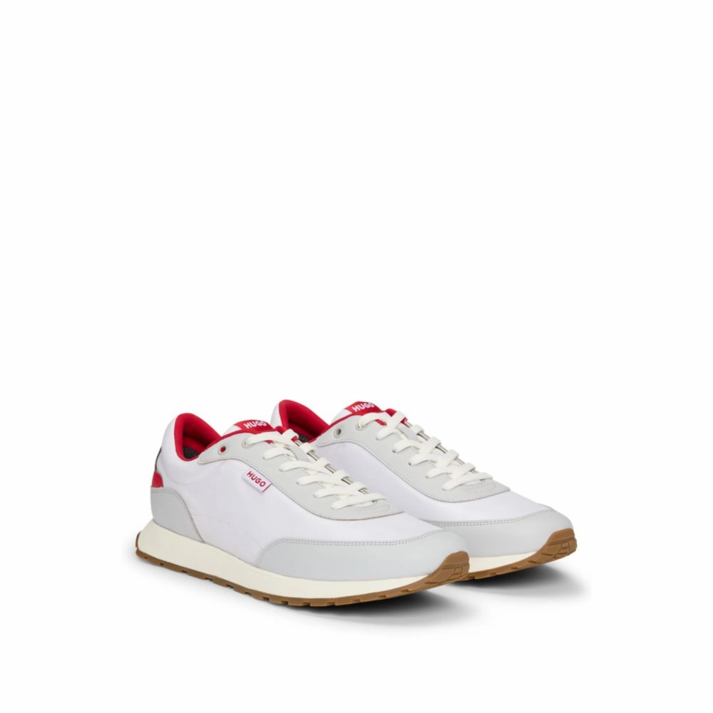 Mixed-material trainers with logo flag dirt path